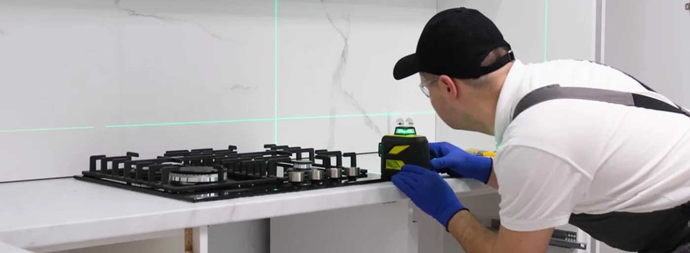 Technician installing a domestic gas hob